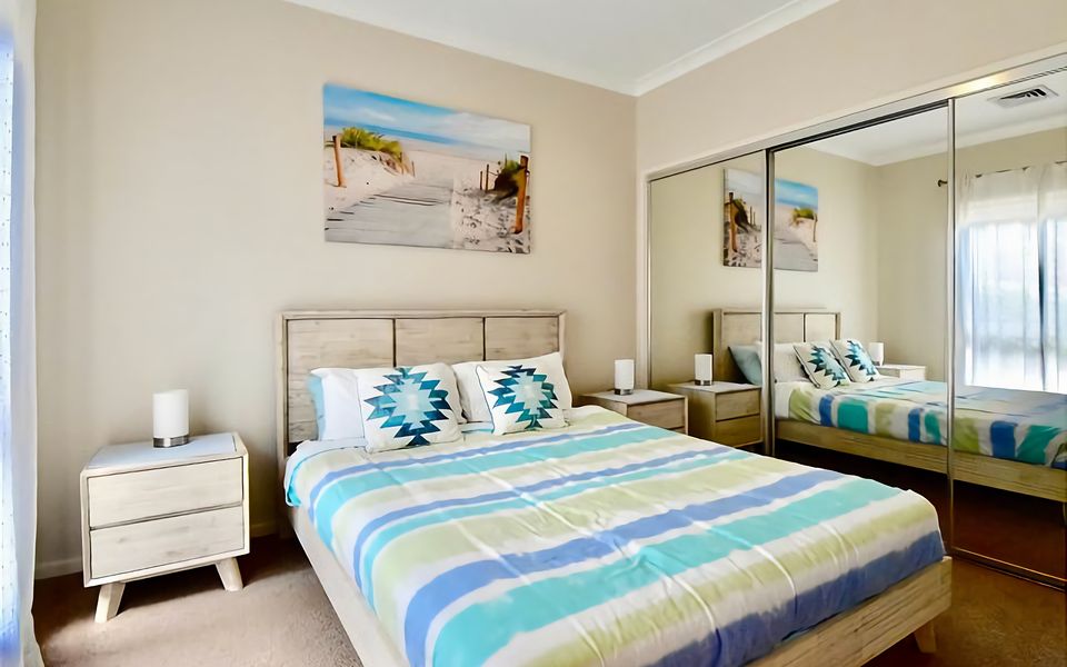 Recharge in this tranquil bedroom with a queen bed.