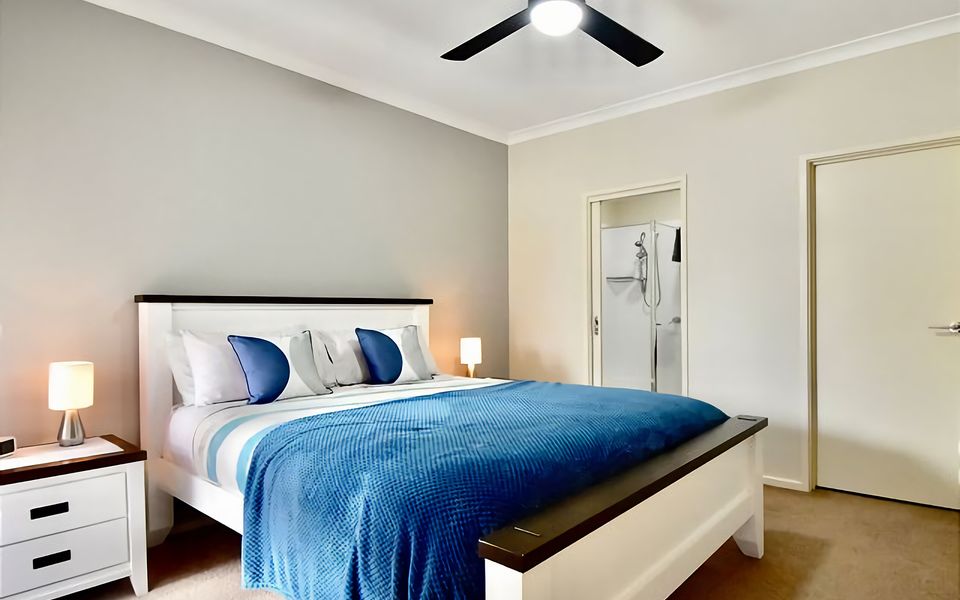 Master bedroom with Queen bed and ensuite with shower, vanity, and toilet.