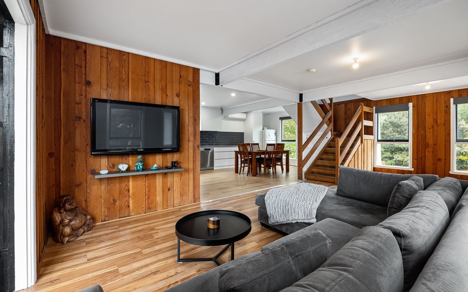 Relax in lounge fitted with a great, big comfy L-shaped couch with large flat screen TV and French door access to the elevated back patio.