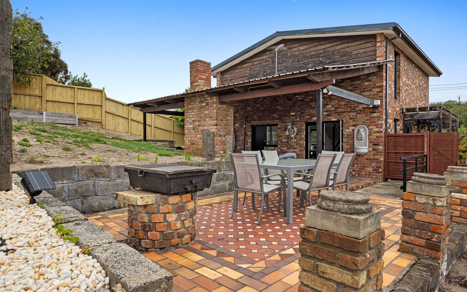 Enjoy the paved alfresco dining for 6 and enormous terraced back yard with lawn and sweeping views.
