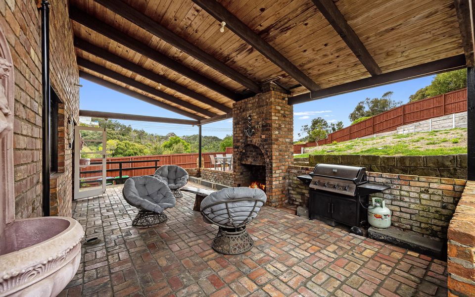Sheltered by a large overhang and set with rattan cushioned chairs around the outdoor fireplace, the patio is a magical spot.