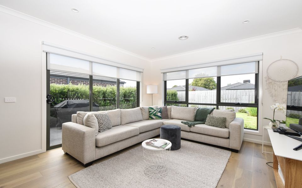 Relax in style in this beautifully appointed lounge room, where modern aesthetics meet comfort. Sink into the plush couch while basking in the natural light streaming through the large windows, creating a serene and inviting ambiance.