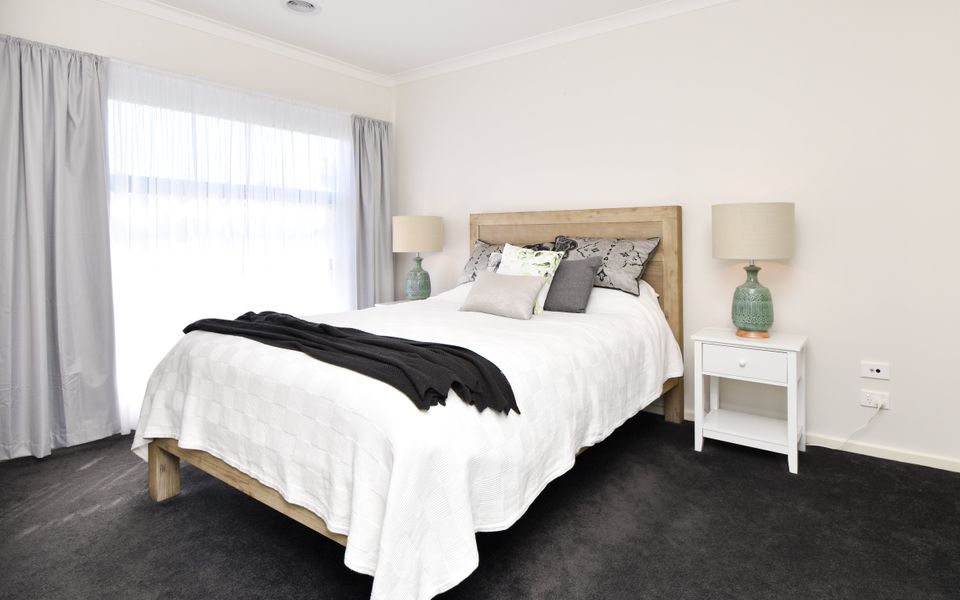 Embrace the comforts of home in our inviting bedroom, furnished with a queen bed and adorned with cozy blankets, creating a cozy ambiance for a peaceful stay.