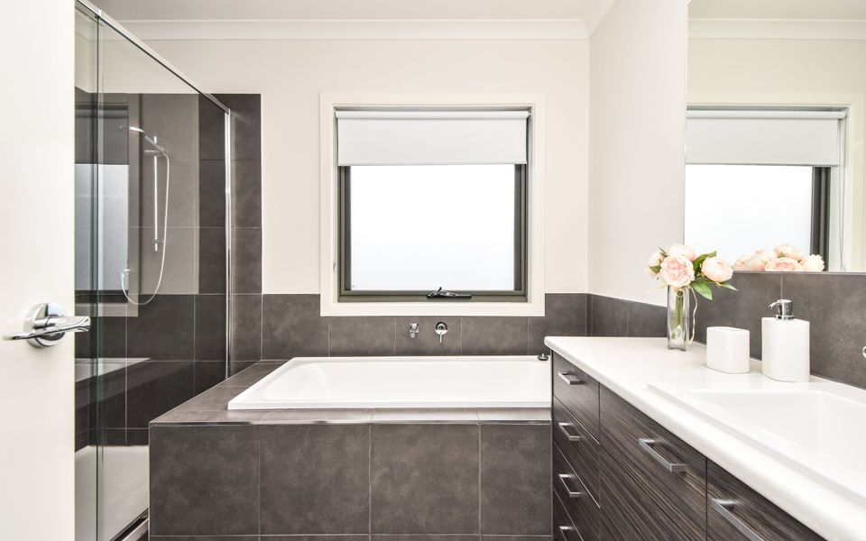 Main bathroom with bath, shower and vanity.