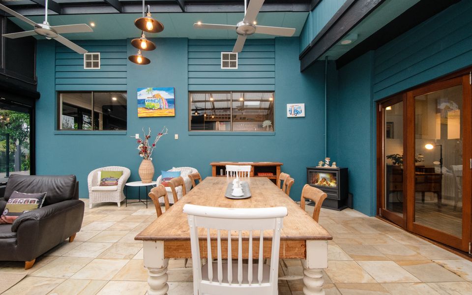The long formal dining table, nestled beside an inviting wood-burning fireplace.