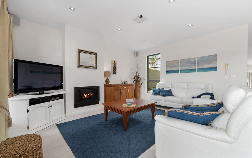 Family lounge area with gas fire place and comfy couches